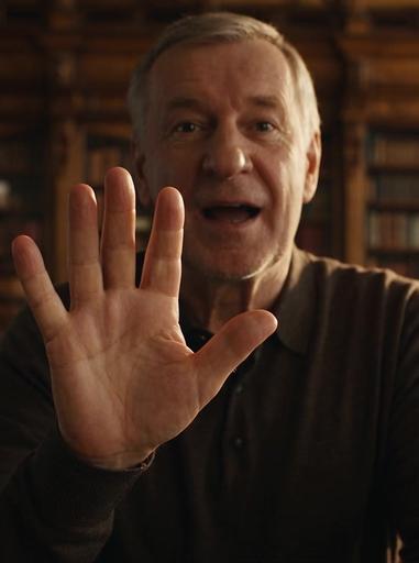 Seedance 2.5: A cinematic, photorealistic medium close-up shot of an expressive, warm-hearted Russian man in his late 50s with gentle 